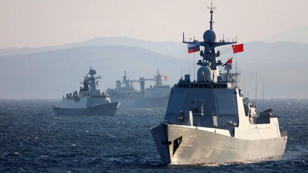 Chinese and Russian warships transit simulated mined sea area during the naval exercise Joint Sea-2021 on the morning of Oct 15. The China-Russia joint naval exercise kicked off in waters near Russia's Peter the Great Bay on the afternoon of Oct 14, which focused on such training subjects as communications, mine countermeasures, air defense, live-fire shooting at maritime targets, joint maneuvering and joint anti-submarine missions.[Photo/Xinhua] - Sputnik India