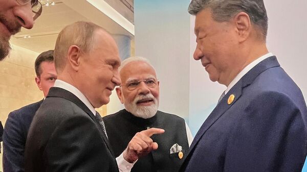 Russian President Vladimir Putin, from left, Indian Prime Minister Narendra Modi and Chinese President Xi Jinping talk ahead of the Shanghai Cooperation Organization (SCO) summit at the Meijiang Convention and Exhibition Center in Tianjin, China, Monday, Sept. 1, 2025. (Indian Prime Minister's Office via AP) - Sputnik India