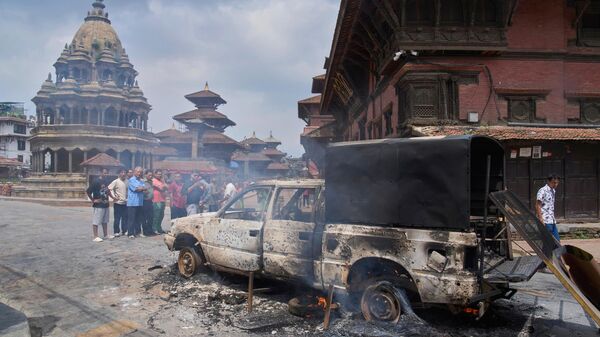 People look at a burnt police vehicle during protests against social media ban and corruption in Kathmandu, Nepal, Tuesday, Sept. 9, 2025.  - Sputnik India