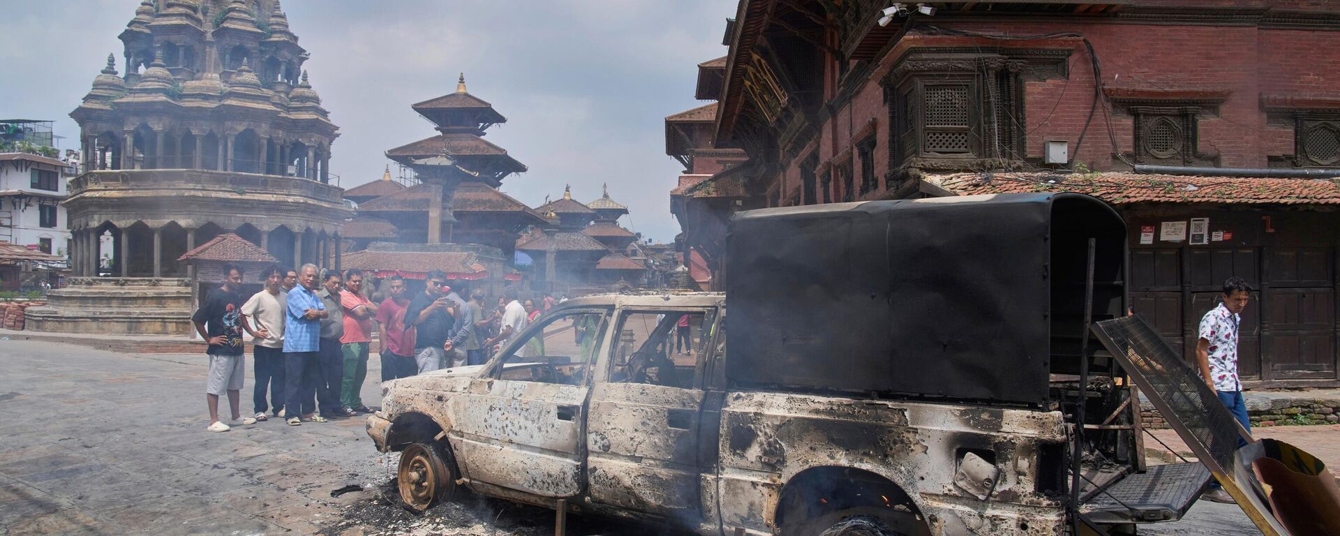 People look at a burnt police vehicle during protests against social media ban and corruption in Kathmandu, Nepal, Tuesday, Sept. 9, 2025.  - Sputnik India, 1920, 09.09.2025