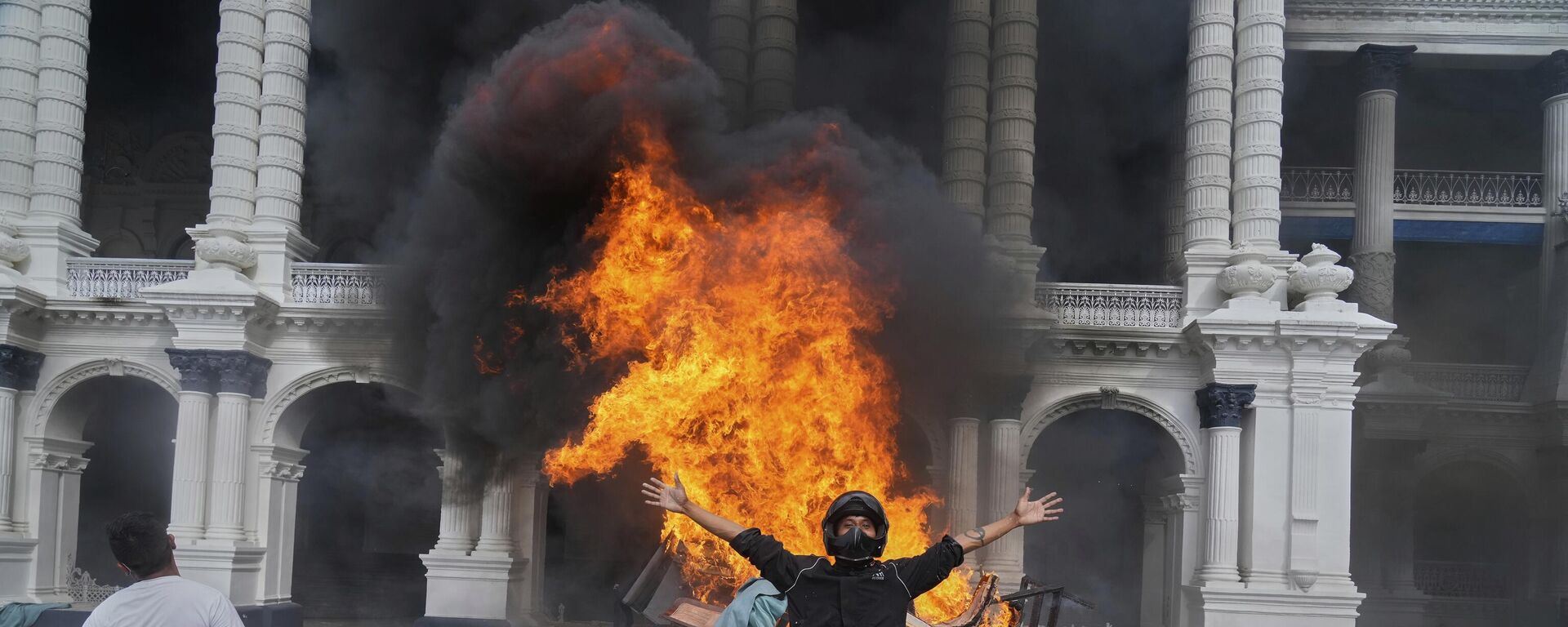 Protesters celebrate at the Singha Durbar, the seat of Nepal's government's various ministries and offices, after it was set on fire during a protest against social media ban and corruption in Kathmandu, Nepal, Tuesday, Sept. 9, 2025.  - Sputnik India, 1920, 07.10.2025
