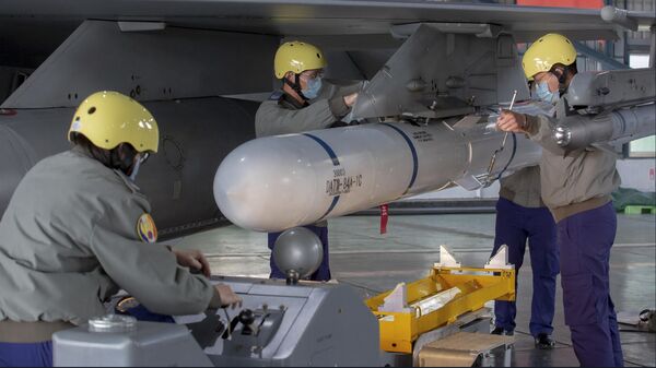 In this photo released by the Taiwan Presidential Office, ground crew attach a missile to the wing of an F-16 jet fighter at Air Force base during a visit by Taiwanese President Tsai Ing-wen, at a military base in Chiayi, southwestern Taiwan, Friday, Jan. 6, 2023.  - Sputnik India