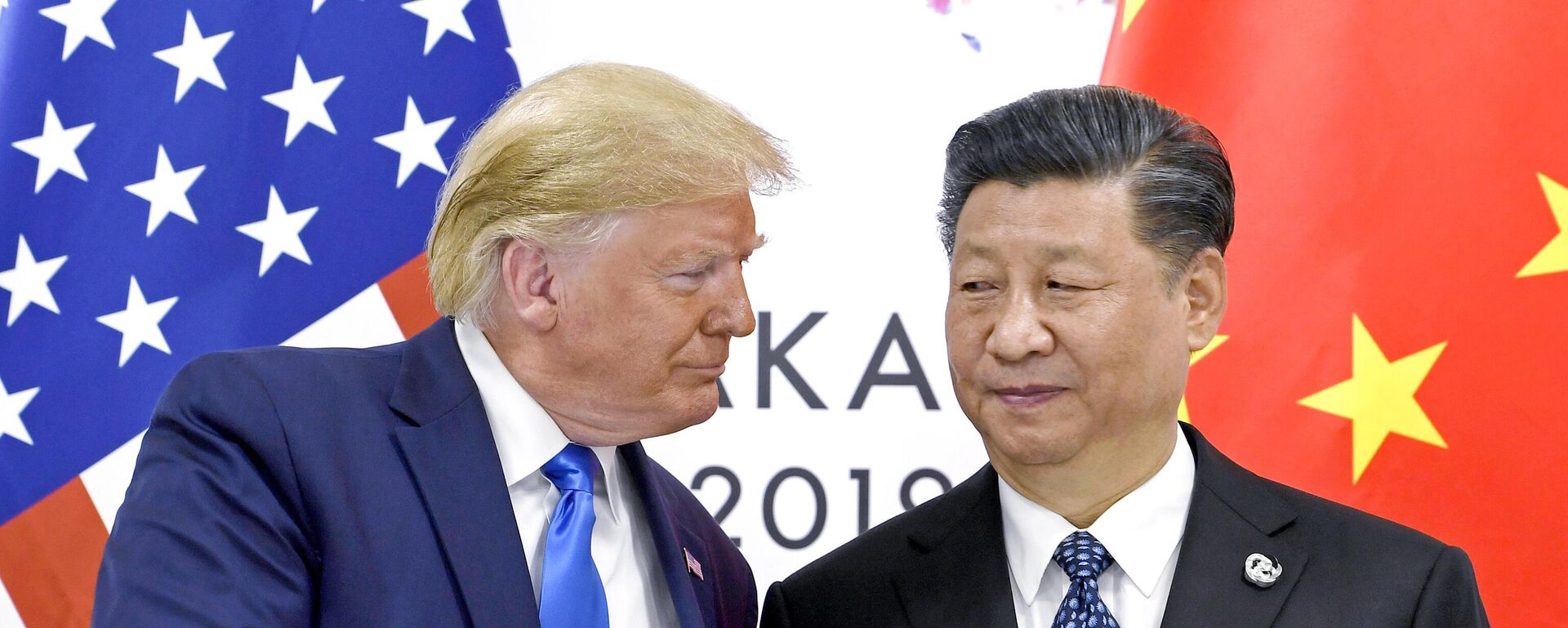 US President Donald Trump, left, shakes hands with China's President Xi Jinping during a meeting on the sidelines of the G-20 summit in Osaka, Japan, June 29, 2019. - Sputnik India, 1920, 23.02.2026