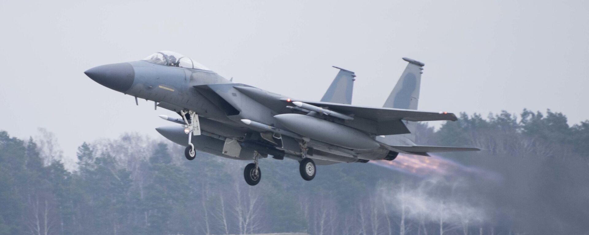 In this image provided by the US Air Force, a US Air Force F-15C Eagle assigned to the 493rd Fighter Squadron, Royal Air Force (RAF) Lakenheath, takes off in support of North Atlantic Treaty Organization enhanced air policing missions with the Polish Air Force at Lask Air Base, Poland, Feb. 15, 2022 - Sputnik India, 1920, 05.04.2026