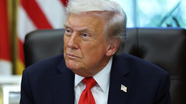 U.S. President Donald Trump looks on during an event celebrating Diwali in the Oval Office of the White House on October 21, 2025 in Washington, DC.  - Sputnik भारत
