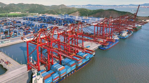 A cargo ship loads and unloads containers in an orderly manner at the Dapukou Container Terminal in Jintang Port Area, Zhoushan Port, Ningbo, Zhejiang, China, on September 9, 2025. - Sputnik India