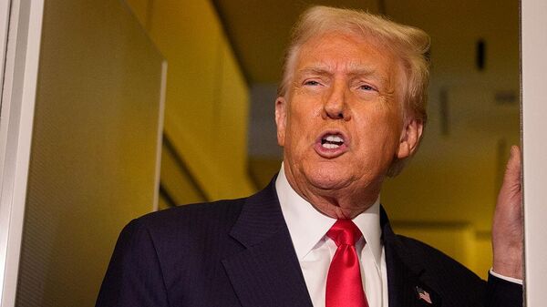 U.S. President Donald Trump speaks to members of the media aboard Air Force One on October 30, 2025 in flight. Trump is returning to Washington following a high-stakes meeting with Chinese President Xi Jinping, alongside securing trade deals with ASEAN, Japanese and South Korean partners on his week-long Asian tour.  - Sputnik भारत