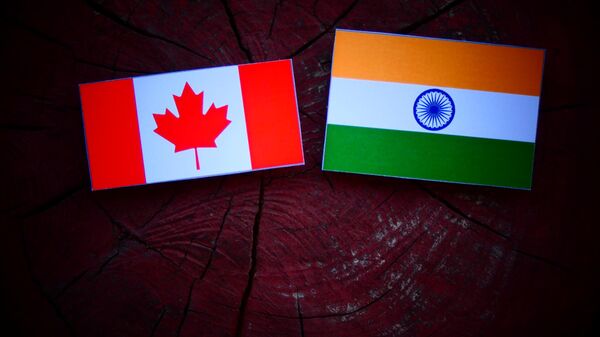 Waving flag of Canada and India - Sputnik India