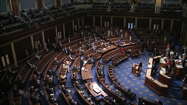In this image from video, members of the House practice social distancing as they sit on the floor and in the public gallery above during debate on the coronavirus stimulus package on the floor of the House of Representatives at the US Capitol in Washington, Friday, March 27, 2020 - Sputnik India