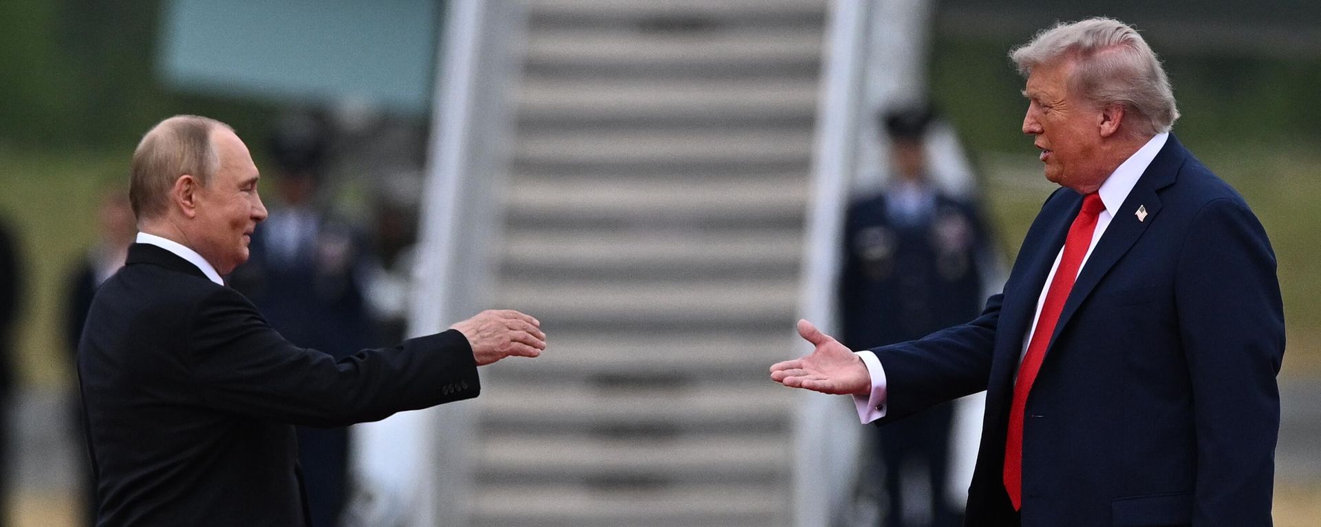 US President Donald Trump greets Russian President Vladimir Putin on the tarmac after they arrived to attend a meeting at Joint Base Elmendorf-Richardson in Anchorage, Alaska, the United States. - Sputnik India, 1920, 02.02.2026