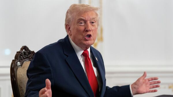 President Donald Trump speaks to reporters after speaking to troops via video from his Mar-a-Lago estate on Thanksgiving, Thursday, Nov. 27, 2025, in Palm Beach, Fla - Sputnik India