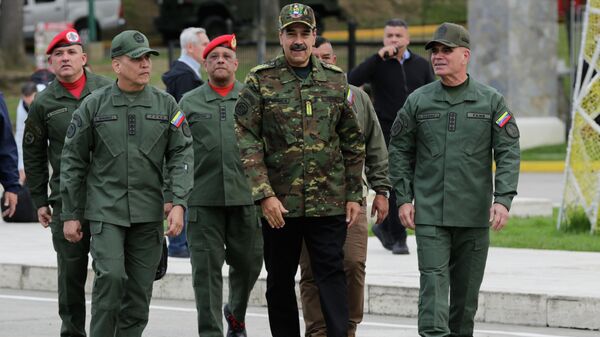 Venezuelan President Nicolas Maduro, center, Defense Minister Vladimir Padrino Lopez, right, and Gen. Domingo Hernandez arrive at a government-organized civic-military rally in Caracas, Venezuela, Tuesday, Nov. 25, 2025 - Sputnik भारत