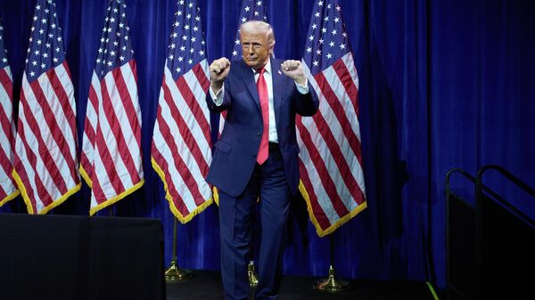President Donald Trump dances as he walks off stage after speaking to House Republican lawmakers during their annual policy retreat, Tuesday, Jan. 6, 2026, in Washington - Sputnik India