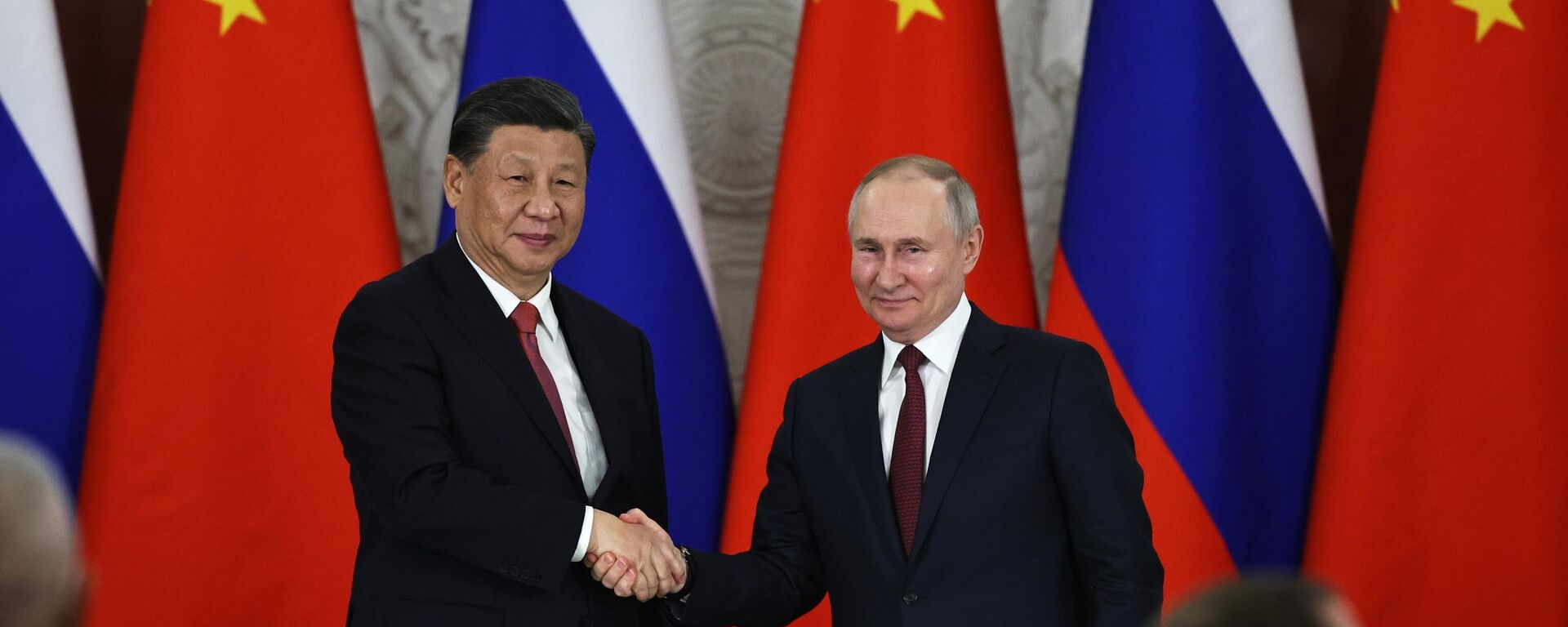 Russian President Vladimir Putin, right, and Chinese President Xi Jinping shake hands after speaking to the media during a signing ceremony following their talks at The Grand Kremlin Palace, in Moscow, Russia, March 21, 2023 - Sputnik India, 1920, 23.01.2026