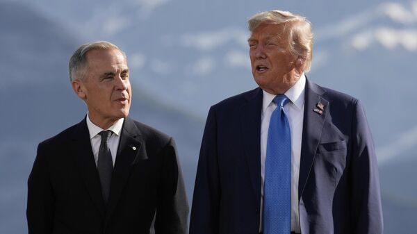 Canada's Prime Minister Mark Carney, listens as President Donald Trump speaks during a group photo at the G7 Summit, Monday, June 16, 2025, in Kananaskis, Canada - Sputnik India