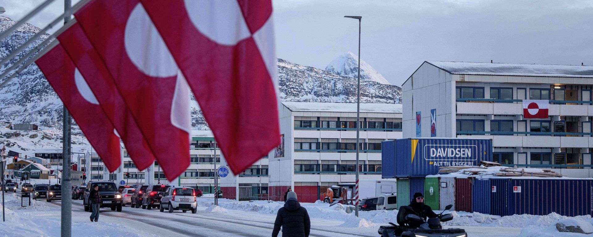 A man rides by on a quad bike past a row of Greenlandic national flags in Nuuk, Greenland, Wednesday, Jan. 14, 2026. - Sputnik भारत, 1920, 19.09.2026