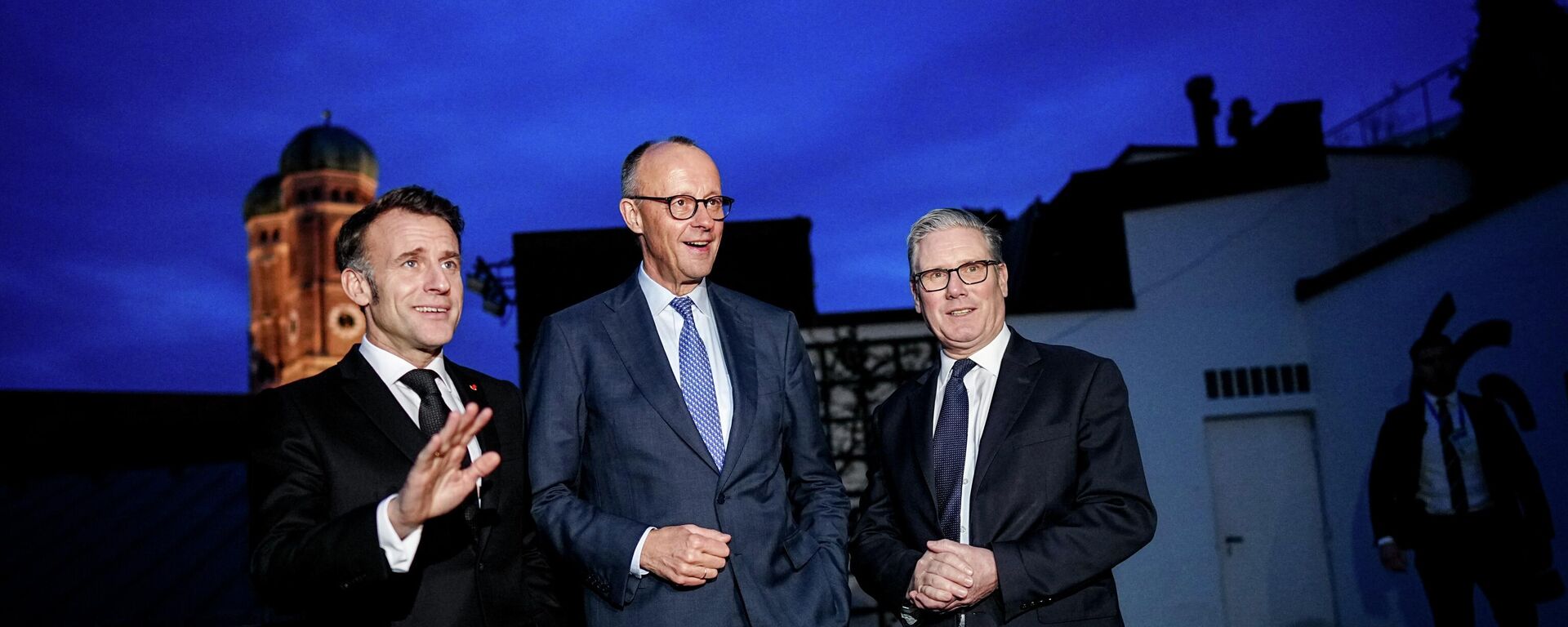 From left, France's President Emmanuel Macron, German Chancellor Friedrich Merz and British Prime Minister Keir Starmer stand together at the 62nd Munich Security Conference (MSC) at the start of the E-3 meeting in Munich, Germany, Friday, Feb. 13, 2026. - Sputnik भारत, 1920, 11.06.2026