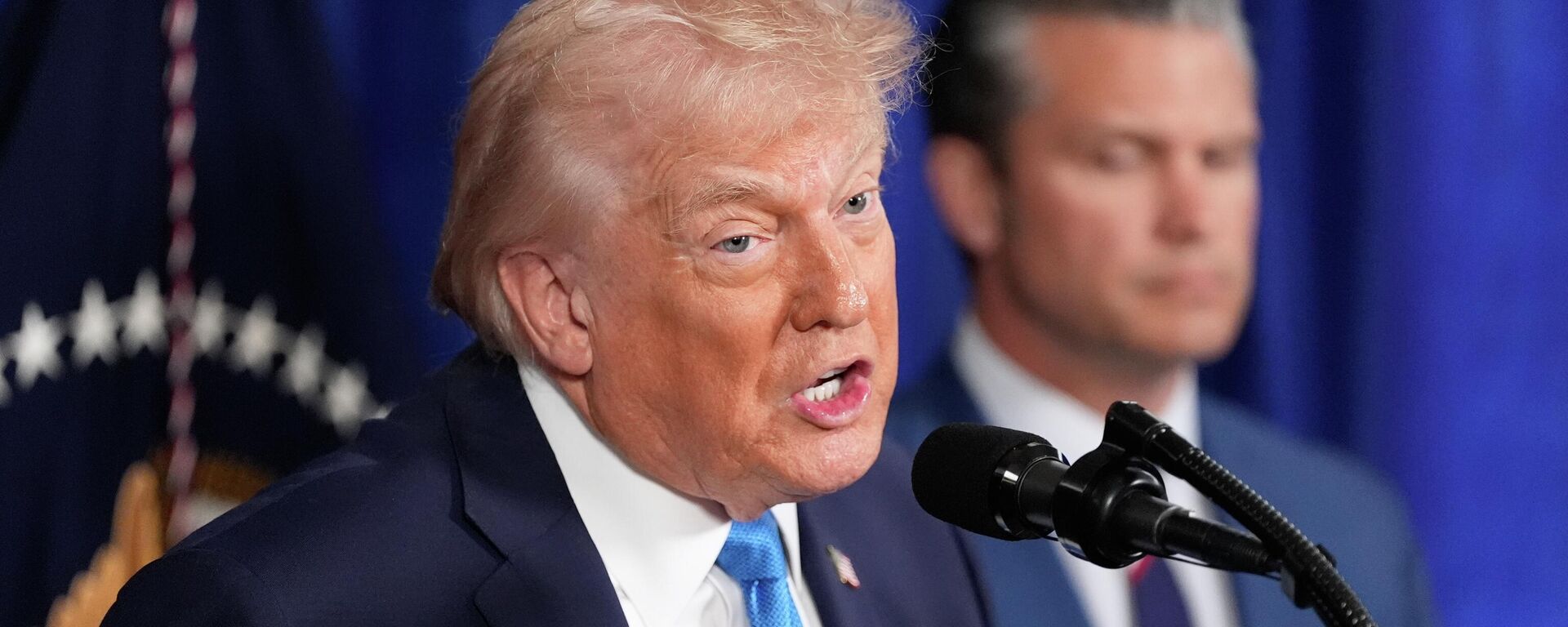 President Donald Trump speaks at his Mar-a-Lago club, Saturday, Jan. 3, 2026, in Palm Beach, Fla., as Defense Secretary Pete Hegseth listens - Sputnik India, 1920, 07.03.2026
