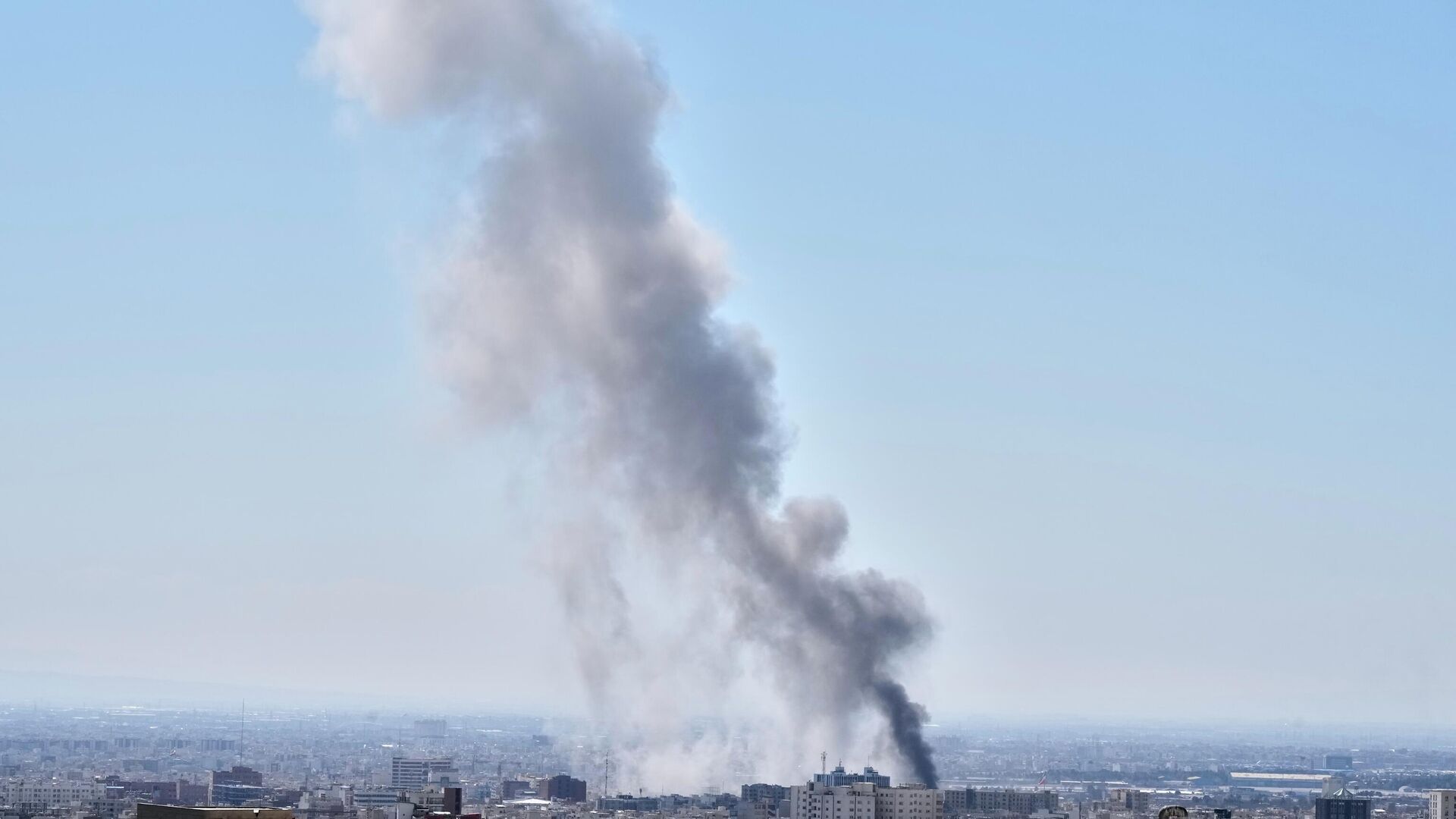 A plume of smoke rises after a strike in Tehran, Iran, Sunday, March 1, 2026. - Sputnik India, 1920, 04.03.2026