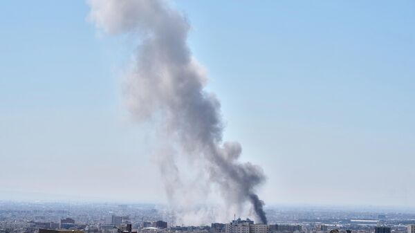 A plume of smoke rises after a strike in Tehran, Iran, Sunday, March 1, 2026. - Sputnik भारत