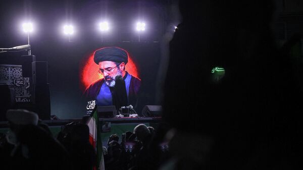 A picture of Iran's new supreme leader, Mojtaba Khamenei, is displayed on a screen in Tehran, amid the U.S.-Israeli conflict with Iran, in Tehran, Iran, March 9, 2026.  - Sputnik भारत