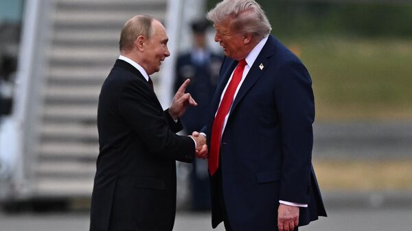 US President Donald Trump greets Russian President Vladimir Putin on the tarmac after they arrived to attend a meeting at Joint Base Elmendorf-Richardson in Anchorage, Alaska, the United States. August 15, 2025. - Sputnik India