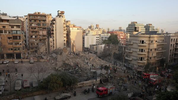 Emergency personnel work at the site of a collapsed building, in the aftermath of an Israeli strike, following an escalation between Hezbollah and Israel amid the U.S.-Israeli conflict with Iran, in central Beirut's Bachoura neighbourhood, Lebanon, March 18, 2026.  - Sputnik भारत