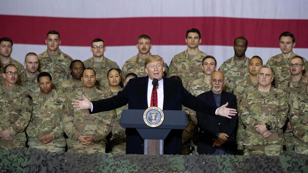 President Donald Trump, center, with Afghan President Ashraf Ghani and Joint Chiefs Chairman Gen. Mark Milley, behind him at right, while addressing members of the military during a surprise Thanksgiving Day visit, Thursday, Nov. 28, 2019, at Bagram Air Field, Afghanistan - Sputnik India