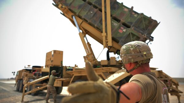 In this photo released by the U.S. Air Force, U.S. Army Spc. Scottlin Bartlett of the 5-52 Air Defense Artillery Battalion signals to a colleague while working near a Patriot missile battery at Al-Dhafra Air Base in Abu Dhabi, United Arab Emirates, May 5, 2021.  - Sputnik India