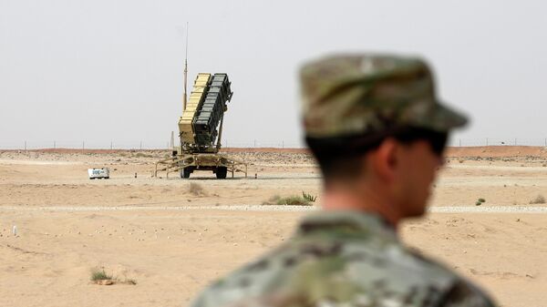 FILE - A member of the U.S. Air Force stands near a Patriot missile battery at the Prince Sultan air base in al-Kharj, central Saudi Arabia, on Feb. 20, 2020. The U.S. has transferred a significant number of Patriot antimissile interceptors to Saudi Arabia in recent weeks as the Biden administration looks to ease what has been a point of tension in the increasingly complicated U.S.-Saudi relationship.   (Andrew Caballero-Reynolds/Pool via AP, File) - Sputnik India