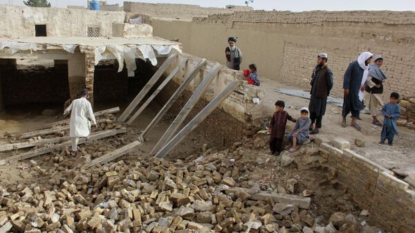 Locals inspect a damaged house following floods, landslides and thunderstorms in Kandahar province, Afghanistan, Sunday, March 29, 2026. - Sputnik India