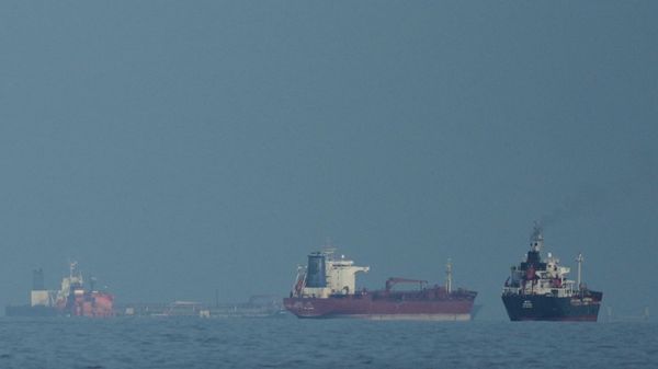 Oil tankers and cargo ships line up in the Strait of Hormuz as seen from Khor Fakkan, United Arab Emirates, Wednesday, March 11, 2026. - Sputnik भारत