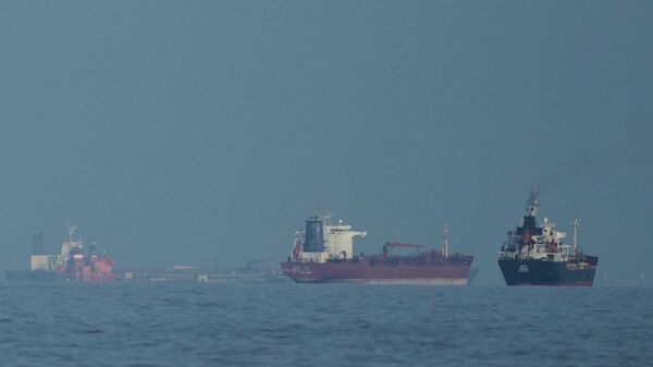 Oil tankers and cargo ships line up in the Strait of Hormuz as seen from Khor Fakkan, United Arab Emirates, Wednesday, March 11, 2026. - Sputnik India