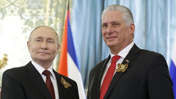 Russian President Vladimir Putin, left, and Cuban President Miguel Diaz-Canel pose for a photo during their meeting at the Great Kremlin Palace at the Kremlin in Moscow, Russia, on Thursday, May 9, 2024 Russian President Vladimir Putin, left, and Cuban President Miguel Diaz-Canel pose for a photo during their meeting at the Great Kremlin Palace at the Kremlin in Moscow, Russia, on Thursday, May 9, 2024 - Sputnik India