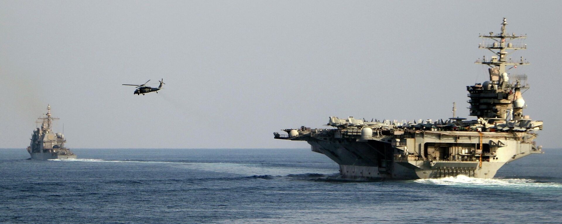 The aircraft carrier USS Dwight D. Eisenhower and other warships crosses the Strait of Hormuz into the Persian Gulf on Sunday. File photo. - Sputnik India, 1920, 17.04.2026