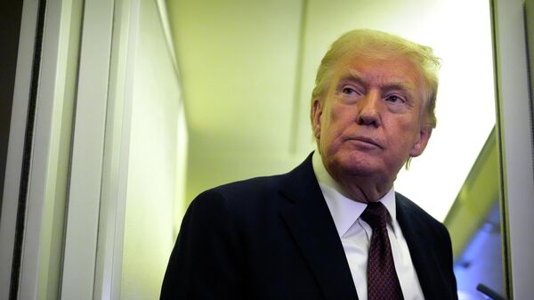 President Donald Trump speaks to reporters aboard Air Force One, Sunday, March 15, 2026, en route from West Palm Beach, Fla. to Joint Base Andrews, Md. - Sputnik भारत