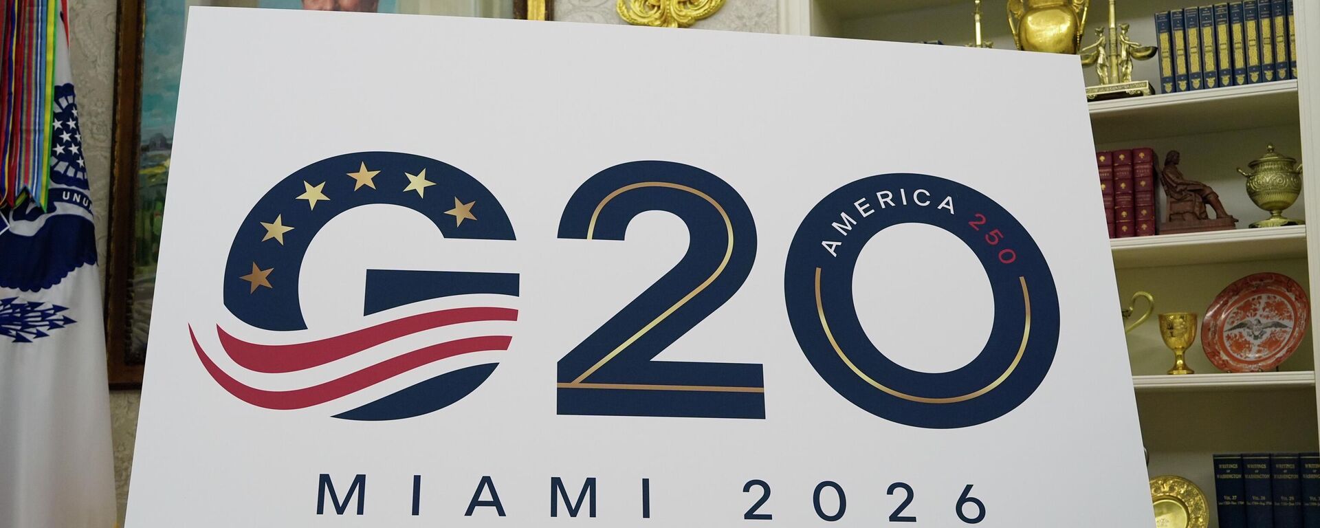 A sign for the G20 to be hosted in Miami in 2026 is displayed as President Donald Trump speaks in the Oval Office of the White House, Friday, Sept. 5, 2025, in Washington. - Sputnik India, 1920, 23.04.2026