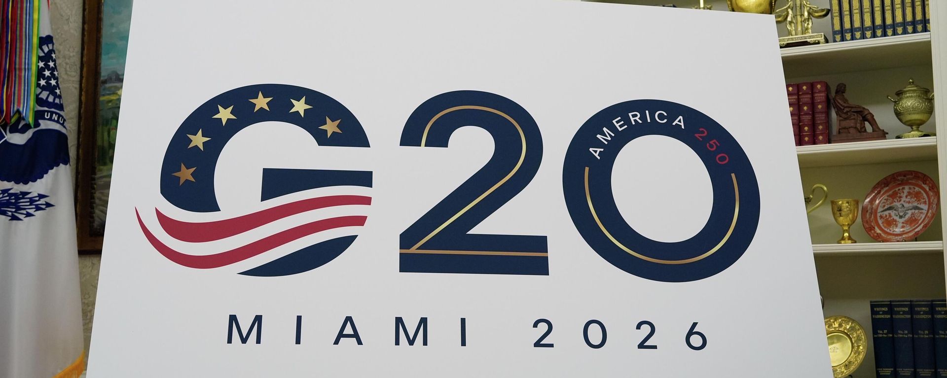 A sign for the G20 to be hosted in Miami in 2026 is displayed as President Donald Trump speaks in the Oval Office of the White House, Friday, Sept. 5, 2025, in Washington. - Sputnik India, 1920, 23.04.2026