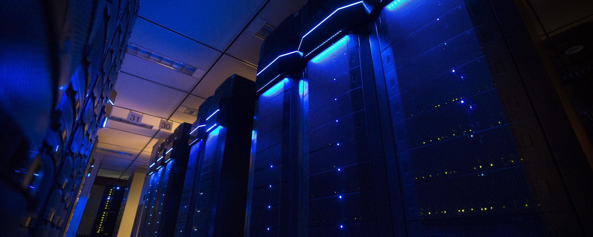This Wednesday, May 20, 2015 photo shows server banks inside a data center at AEP headquarters in Columbus, Ohio. Like most big utilities, AEP's power plants, substations and other vital equipment are managed by a network that is separated from the company's business software with layers of authentication, and is not accessible via the Internet. Creating that separation, and making sure that separation is maintained, is among the most important things utilities can do to protect the grid's physical assets. (AP Photo/John Minchillo) - Sputnik भारत, 1920, 24.04.2026
