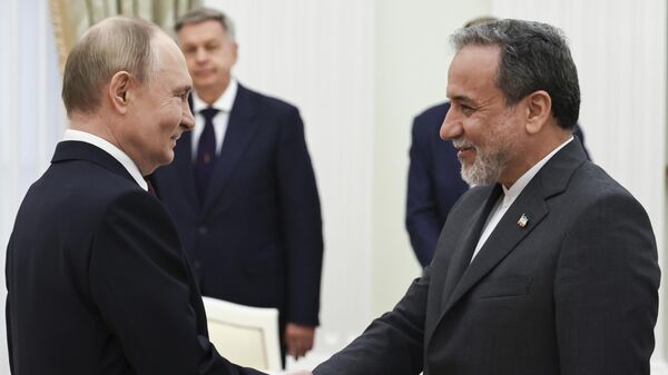 Russian President Vladimir Putin, left, greets Iranian Foreign Minister Abbas Araghchi prior to their talks at the Kremlin in Moscow, Russia, Monday, June 23, 2025. - Sputnik India