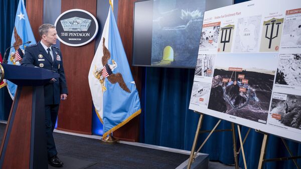 Joint Chiefs Chairman Gen. Dan Caine watches a test video of the ordinance used in the attack on the Iranian Fordow Fuel Enrichment Plant during a news conference at the Pentagon, Thursday, June 26, 2025 in Washington.  - Sputnik भारत