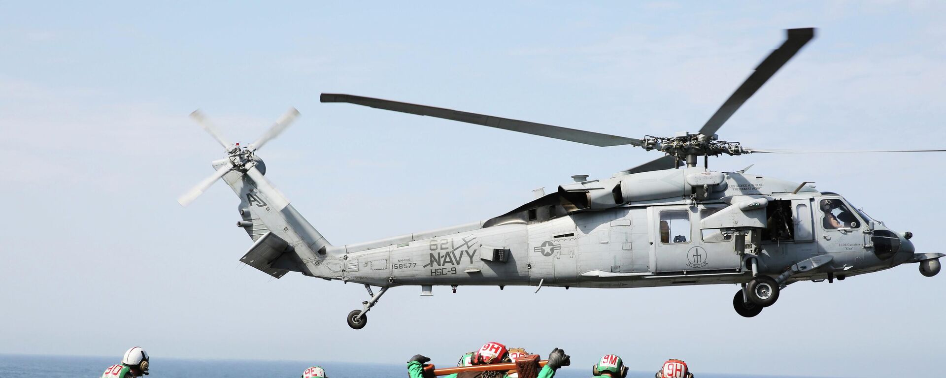 In this March 20, 2017 photograph, an MH-60 helicopter takes off from the USS George H.W. Bush as it travels toward the Strait of Hormuz.  - Sputnik भारत, 1920, 05.05.2026