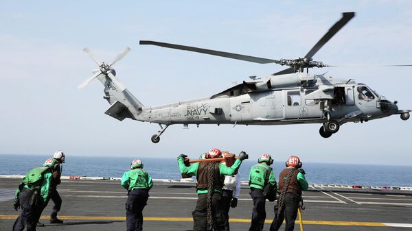 In this March 20, 2017 photograph, an MH-60 helicopter takes off from the USS George H.W. Bush as it travels toward the Strait of Hormuz.  - Sputnik भारत