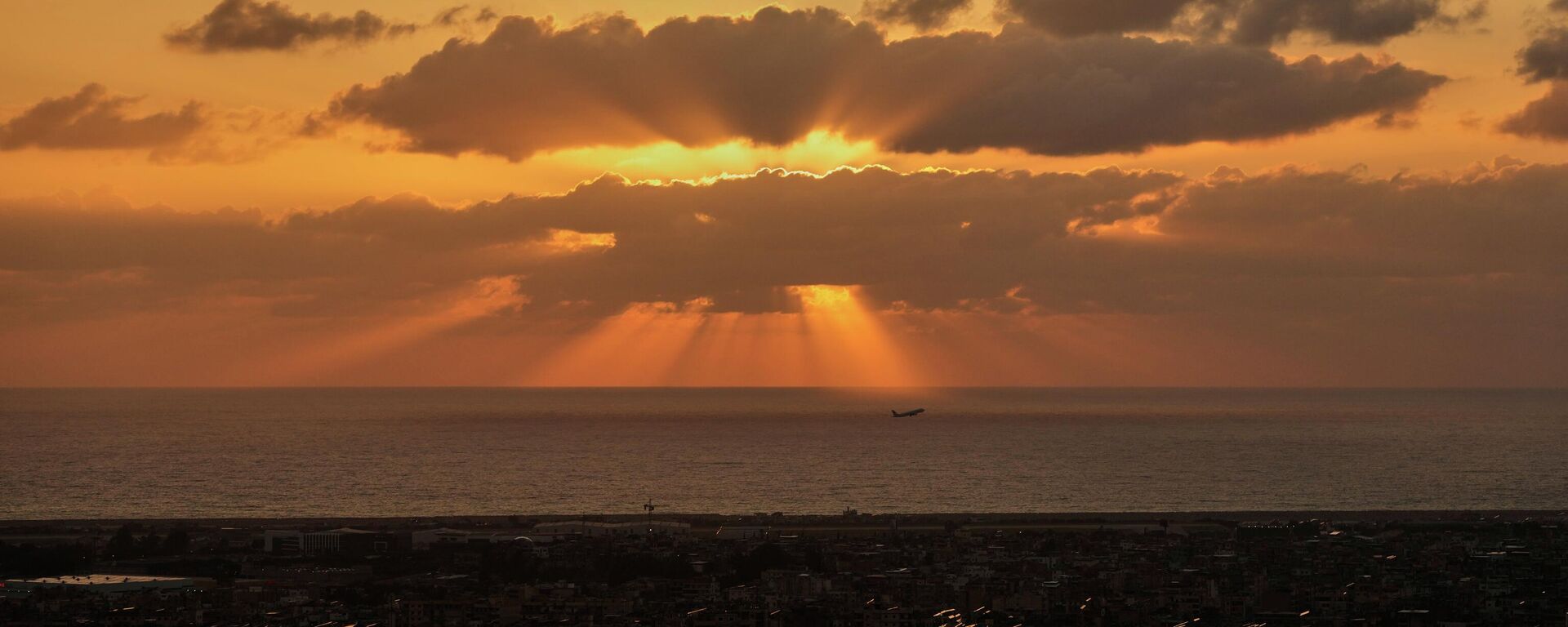 A Middle East Airlines plane takes off as the sun sets over Dahiyeh, Beirut's southern suburbs, which remain in darkness following Israeli airstrikes, in Beirut, Lebanon, Monday, March 16, 2026. - Sputnik India, 1920, 11.05.2026