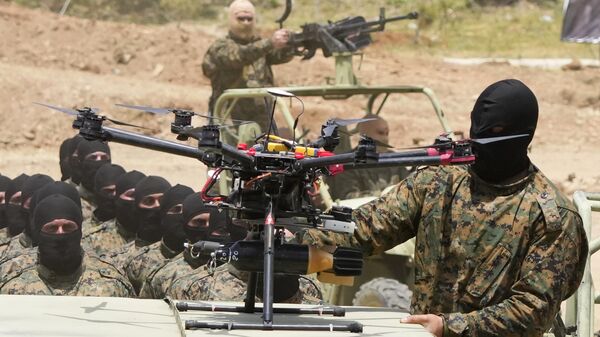 A Hezbollah fighter stands next to an armed drone during a training exercise in Aaramta village in the Jezzine District, southern Lebanon, on May 21, 2023 - Sputnik भारत