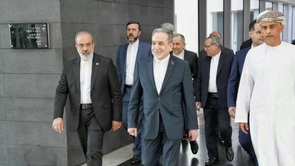 In this photo released by the Iranian Foreign Ministry, Iranian Foreign Minister Abbas Araghchi, center, heads to venue for talks between Iran and the U.S., in Muscat, Oman, Friday, Feb. 6, 2026.  - Sputnik भारत