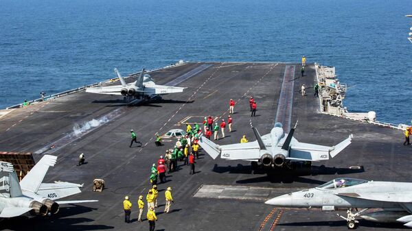 This image provided by U.S. Central Command shows a F/A-18E Super Hornet launching at left, as an F/A-18E Super at right, prepares to launch from the flight deck of Nimitz-class aircraft carrier USS Abraham Lincoln (CVN 72) in support of Operation Epic Fury, on Saturday, Feb. 28, 2026 - Sputnik भारत