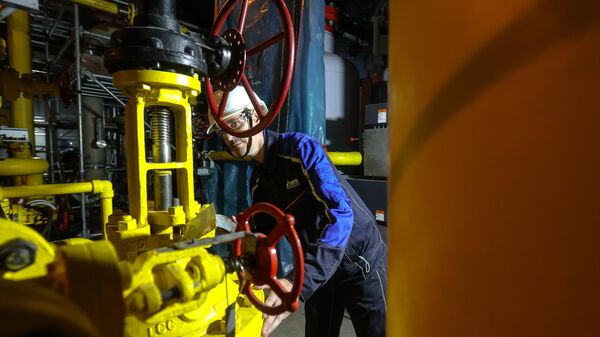 A technician inspects the shut-off and regulating valve in the compressor hall of the heat pump at the Amur Gas Processing Plant, which processes gas supplied via the Power of Siberia pipeline, with a projected capacity of 42 billion cubic meters of gas per year. - Sputnik India