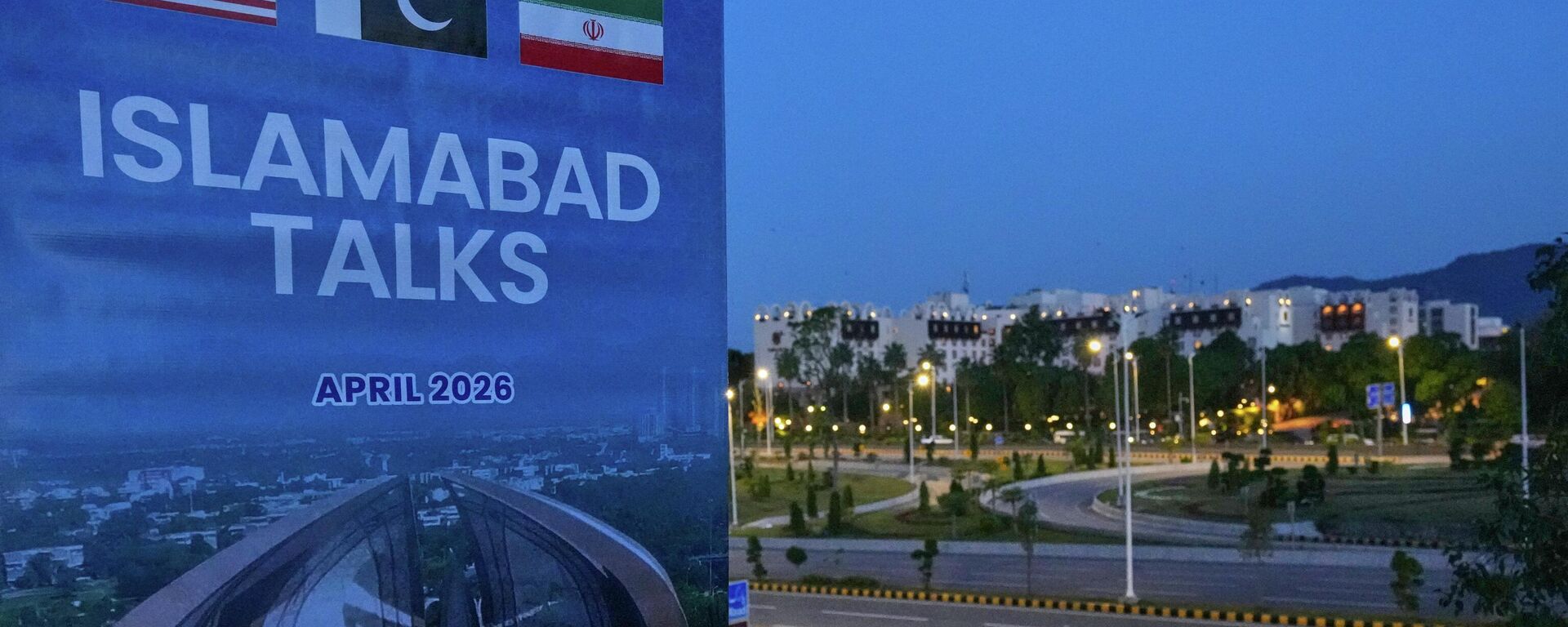 A billboard of the U.S. Iran talks is seen near Serena Hotel, the venue for the U.S. Iran officials meeting, in Islamabad, Pakistan, Sunday, April 12, 2026. (AP Photo/Anjum Naveed) - Sputnik भारत, 1920, 09.06.2026