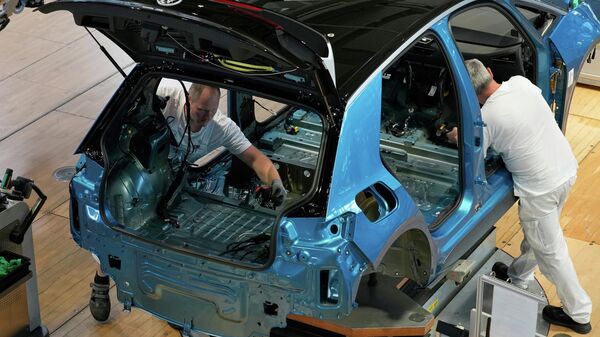 Employees of the German car manufacturer Volkswagen assemble an ID.3 electric car at the transparent factory in Dresden, Germany, Wednesday. - Sputnik India